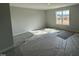 Bedroom with neutral paint and carpet offering natural light from a large window at 188 Tuskeegee Dr, Smithfield, NC 27577