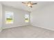 Light-filled bedroom with two windows, neutral walls, and ceiling fan providing a comfortable space at 188 Tuskeegee Dr, Smithfield, NC 27577