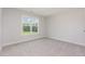 Bright bedroom with plush carpet and a large window showcasing a beautiful outdoor view at 188 Tuskeegee Dr, Smithfield, NC 27577