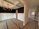 Elegant dining room featuring a coffered ceiling, wainscoting, and a modern chandelier at 188 Tuskeegee Dr, Smithfield, NC 27577
