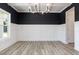 Elegant dining room featuring wainscoting, wood floors, and a modern chandelier at 188 Tuskeegee Dr, Smithfield, NC 27577