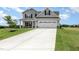 Charming two-story home featuring a gray exterior, attached garage, and a well manicured lawn at 188 Tuskeegee Dr, Smithfield, NC 27577