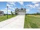 Well-manicured lawn with charming gray two-story home featuring an attached garage at 188 Tuskeegee Dr, Smithfield, NC 27577