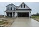 New two-story home featuring an attached two-car garage, gray siding, and a covered front porch at 188 Tuskeegee Dr, Smithfield, NC 27577