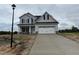 Two-story home featuring a two-car garage and a concrete driveway at 188 Tuskeegee Dr, Smithfield, NC 27577