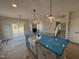 Kitchen island with a farmhouse sink and modern pendant lighting, offering a view to the living area at 188 Tuskeegee Dr, Smithfield, NC 27577