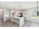 Modern kitchen featuring gray cabinets, a spacious island with white countertop, and stainless steel appliances at 188 Tuskeegee Dr, Smithfield, NC 27577
