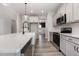 Bright kitchen featuring stainless steel appliances, a spacious island, and white cabinets with modern hardware at 188 Tuskeegee Dr, Smithfield, NC 27577