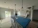 Open-concept kitchen featuring an island with a farmhouse sink, modern pendant lights, and stainless steel appliances at 188 Tuskeegee Dr, Smithfield, NC 27577