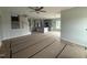 Spacious living area featuring an open floor plan, modern light fixtures, and access to the kitchen and staircase at 188 Tuskeegee Dr, Smithfield, NC 27577