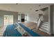Bright living room with a fireplace, large sliding glass doors and a staircase at 188 Tuskeegee Dr, Smithfield, NC 27577