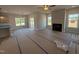 Bright living room with fireplace, large windows, and open floor plan at 188 Tuskeegee Dr, Smithfield, NC 27577