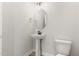 Compact powder room with pedestal sink, oval mirror, and modern fixtures; designed for guest convenience at 188 Tuskeegee Dr, Smithfield, NC 27577