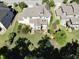 Aerial view of the home's backyard featuring a well-manicured lawn and mature landscaping at 1927 Napoli Dr, Apex, NC 27502