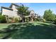 Spacious backyard with lush green lawn, mature trees, and a garden area, perfect for outdoor living at 1927 Napoli Dr, Apex, NC 27502