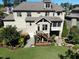 Multi-story home with a private backyard, lush landscaping, a deck, and a covered patio area at 1927 Napoli Dr, Apex, NC 27502