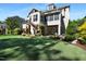 Expansive backyard featuring a wooden deck, patio, and lush landscaping at 1927 Napoli Dr, Apex, NC 27502