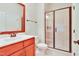 Modern bathroom featuring tiled walk-in shower and cherry wood vanity at 1927 Napoli Dr, Apex, NC 27502
