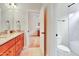 Bathroom features a dual sink vanity with granite countertop and a separate toilet and shower at 1927 Napoli Dr, Apex, NC 27502