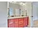 Bathroom features a dual sink vanity with granite countertop and updated lighting at 1927 Napoli Dr, Apex, NC 27502