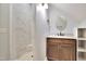 Modern bathroom features tiled shower and vanity with a round mirror at 1927 Napoli Dr, Apex, NC 27502