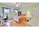 Bright bedroom features a decorative window with purple accents, desk, and stylish furniture at 1927 Napoli Dr, Apex, NC 27502