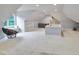 Spacious bonus room offers window bench seating, wet bar, and plush carpet at 1927 Napoli Dr, Apex, NC 27502