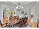 Formal dining room with elegant chandelier and hardwood flooring at 1927 Napoli Dr, Apex, NC 27502