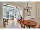 Dining room with hardwood floors, chandelier, and view into the sunroom is the perfect spot for Gathering meals at 1927 Napoli Dr, Apex, NC 27502