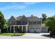 Charming two-story home featuring a three-car garage and a welcoming front porch at 1927 Napoli Dr, Apex, NC 27502