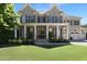 Stately brick home with large front porch and meticulously manicured lawn at 1927 Napoli Dr, Apex, NC 27502