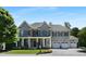Elegant two-story house featuring a brick facade, a three-car garage, and well-maintained landscaping at 1927 Napoli Dr, Apex, NC 27502