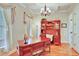 Bright office space with hardwood floors, a window, and a large wooden desk and cabinet at 1927 Napoli Dr, Apex, NC 27502