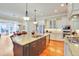 Open kitchen with granite countertops, stainless steel appliances, and a large island with a sink at 1927 Napoli Dr, Apex, NC 27502