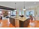 Open-concept kitchen flowing into living and dining areas, featuring a central island and modern appliances at 1927 Napoli Dr, Apex, NC 27502