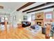Cozy living room with hardwood floors, a stone fireplace, and comfortable seating at 1927 Napoli Dr, Apex, NC 27502
