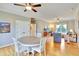 Open-concept living and dining area featuring hardwood floors and lots of natural light at 1927 Napoli Dr, Apex, NC 27502