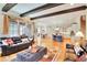 Spacious living room boasts hardwood floors, exposed beams, a large window, and an open layout into the dining room and kitchen at 1927 Napoli Dr, Apex, NC 27502