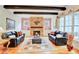 Inviting living room features a stone fireplace, hardwood floors, and comfortable seating, perfect for relaxing and entertaining guests at 1927 Napoli Dr, Apex, NC 27502