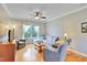 Inviting living room with large window, stylish furniture and a ceiling fan at 1927 Napoli Dr, Apex, NC 27502