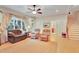 Bright living room featuring hardwood floors, comfortable seating and a ceiling fan at 1927 Napoli Dr, Apex, NC 27502