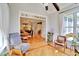 Open-concept living space featuring hardwood floors and lots of natural light connects seamlessly to the dining room and kitchen at 1927 Napoli Dr, Apex, NC 27502