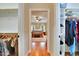 View of main bedroom with hardwood floors from and walk-in closets, which have custom shelving and storage at 1927 Napoli Dr, Apex, NC 27502