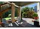 Covered patio featuring brick columns, comfortable seating, and a peaceful outdoor space at 1927 Napoli Dr, Apex, NC 27502