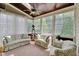 Cozy sunroom featuring lots of windows, natural light, and comfortable seating is the perfect place to unwind at 1927 Napoli Dr, Apex, NC 27502