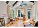Bright sunroom with vaulted ceiling, exposed beams, lots of natural light, and hardwood floors is the perfect place to relax at 1927 Napoli Dr, Apex, NC 27502