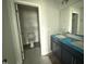 Well-lit bathroom with a dual sink vanity and an adjacent toilet area for added convenience at 202 Tuskeegee Dr, Smithfield, NC 27577