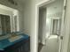 Bright bathroom featuring a single sink vanity with a large mirror at 202 Tuskeegee Dr, Smithfield, NC 27577