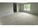 Large bedroom space with an abundance of natural light from the window and neutral paint at 202 Tuskeegee Dr, Smithfield, NC 27577