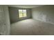 Bedroom with a window, neutral colored walls and white trim at 202 Tuskeegee Dr, Smithfield, NC 27577
